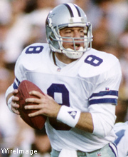 Pro Football Hall of Famer Troy Aikman wearing number 8 for the Dallas Cowboys dropping back for a pass