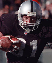 Pro Football Hall of Famer Tim Brown wearing number 81 for the Oakland Raiders catching the ball