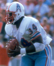 Pro Football Hall of Famer Earl Campbell wearing number 34 for the Houston Oilers rushing the ball