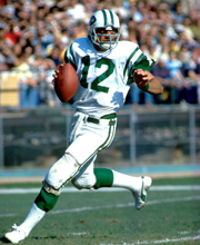 Pro Football Hall of Famer Joe Namath wearing number 12 for the New York Jets dropping back for a pass