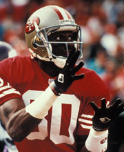 Pro Football Hall of Famer Jerry Rice wearing number 80 for the San Francisco 49ers catching a ball