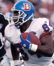 Pro Football Hall of Famer Shannon Sharpe wearing number 84 for the Denver Broncos catching the ball