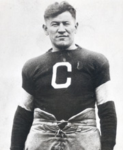 Pro Football Hall of Famer Jim Thorpe posing for a photo wearing a Canton Bulldogs jersey