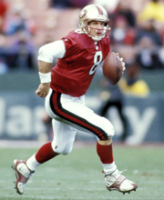 Pro Football Hall of Famer Steve Young wearing number 8 for the San Francisco 49ers scrambling to pass